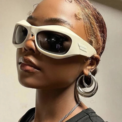 Person wearing futuristic sunglasses with a neutral background
