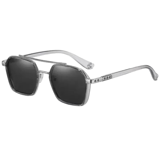 Sunglasses with silver frame and dark lenses on a white background